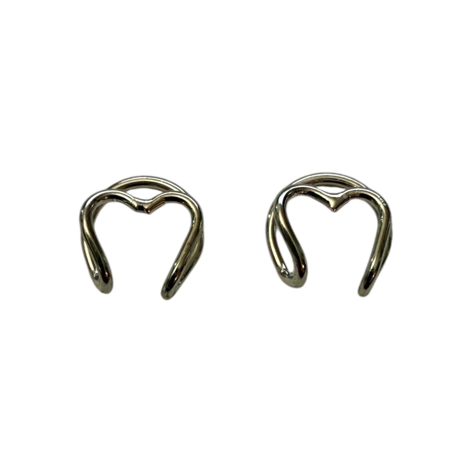 Pair of silver heart cuff earrings on a white background