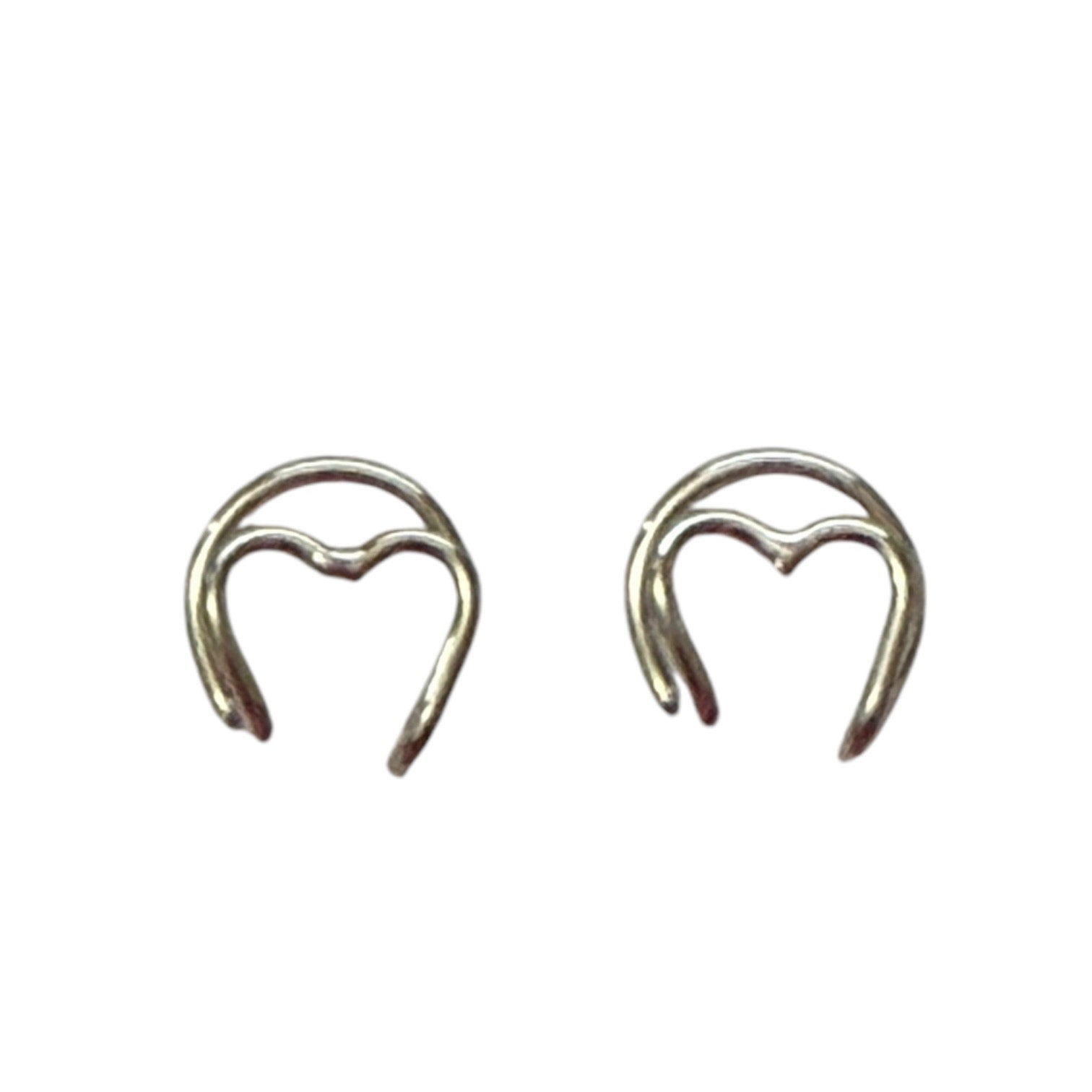 Pair of silver heart-shaped earring cuff on a white background