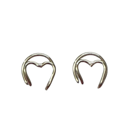 Pair of silver heart-shaped earring cuff on a white background