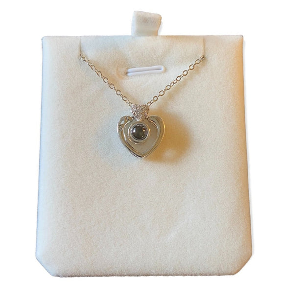 Heart-shaped pendant necklace on a white display card