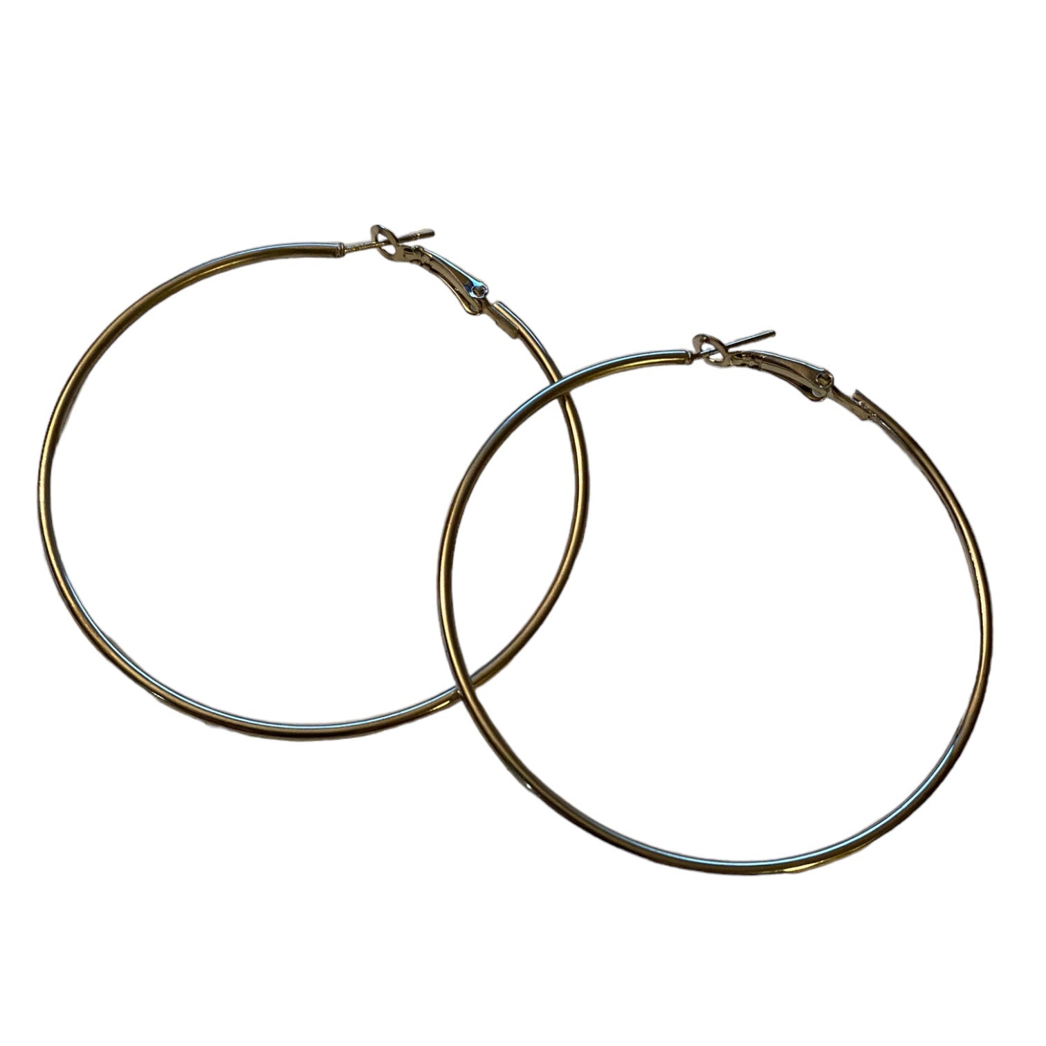 A pair of large, hoop earrings with a polished silver-tone finish, displayed against a solid white background.