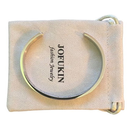 Top of silver cuff bracelet on a beige dust cover