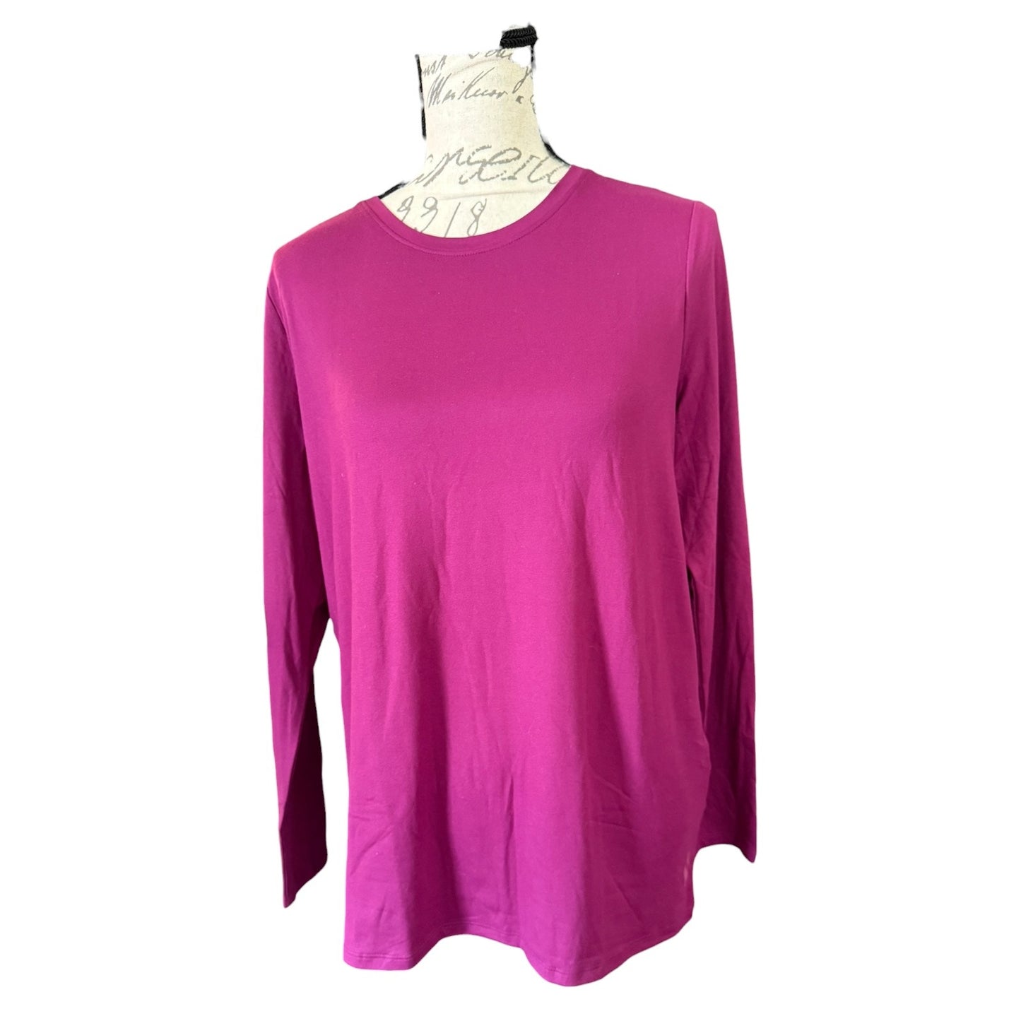 A purple long-sleeve crewneck top displayed on a dress form mannequin against a plain white background.