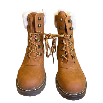 Front of brown leather boots with white fur lining on a white background