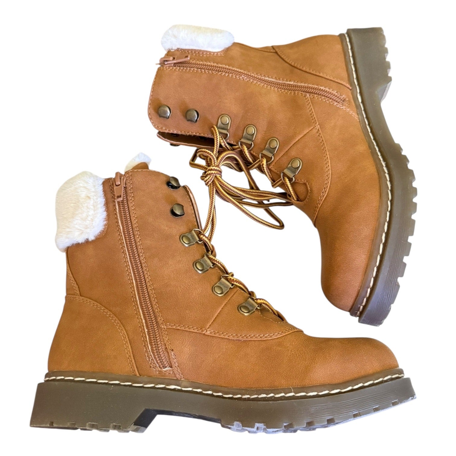 Side of brown winter boots with white fur lining on a white background