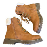 Side of brown winter boots with white fur lining on a white background