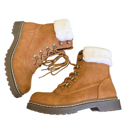 Side of brown leather boots with white fur lining on a white background
