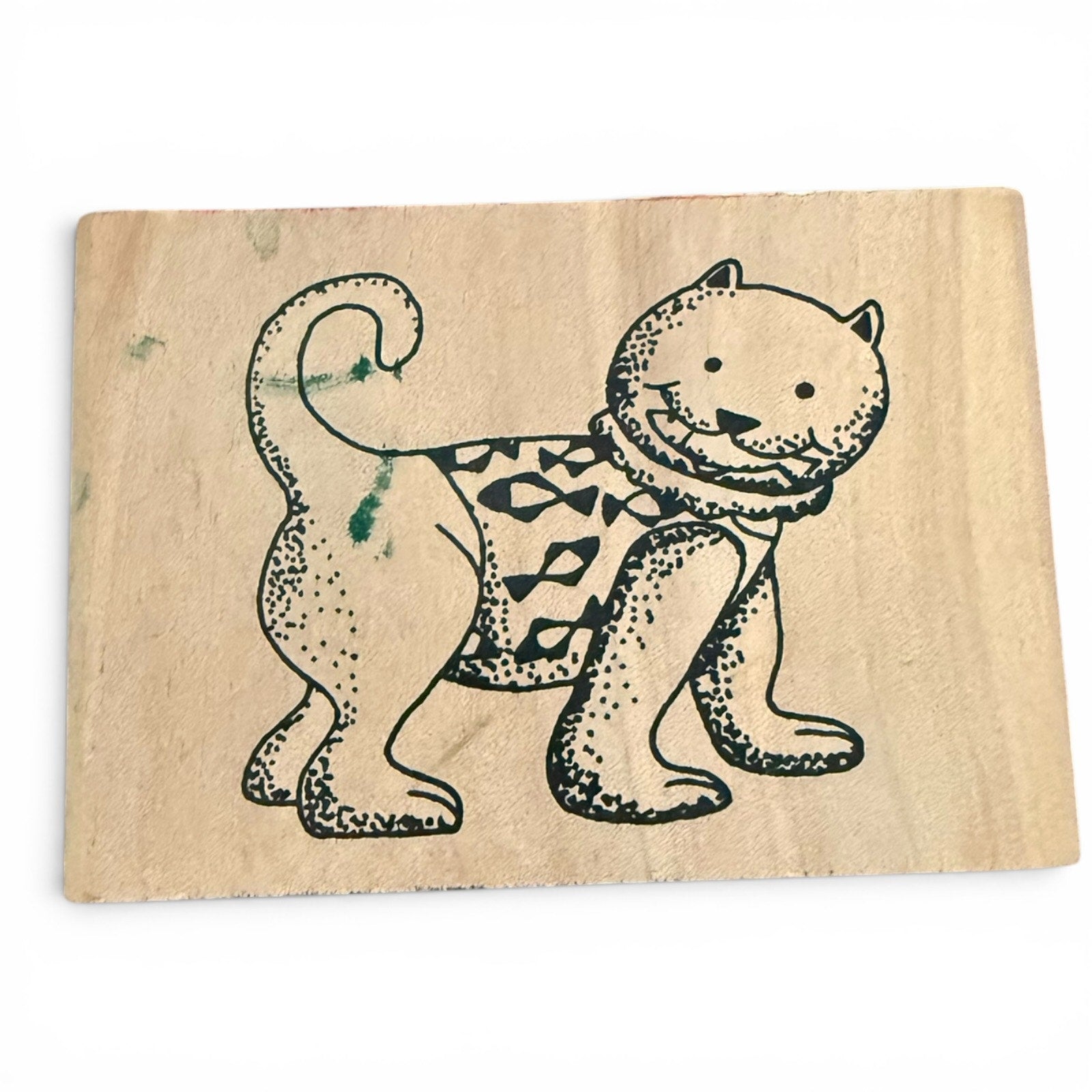 Wooden stamp with a cat design on a white background
