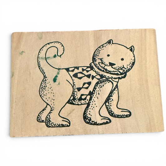 Wooden stamp with a cat design on a white background