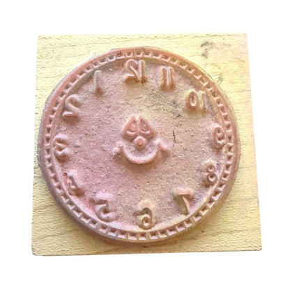 Rubber stamp with clock design on a wooden block