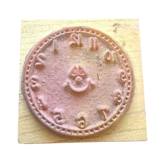 Rubber stamp with clock design on a wooden block