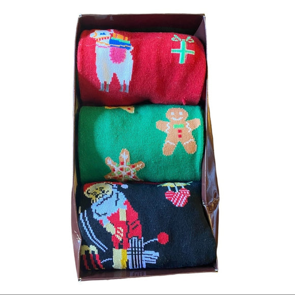Set of three colorful socks with festive designs in a box.