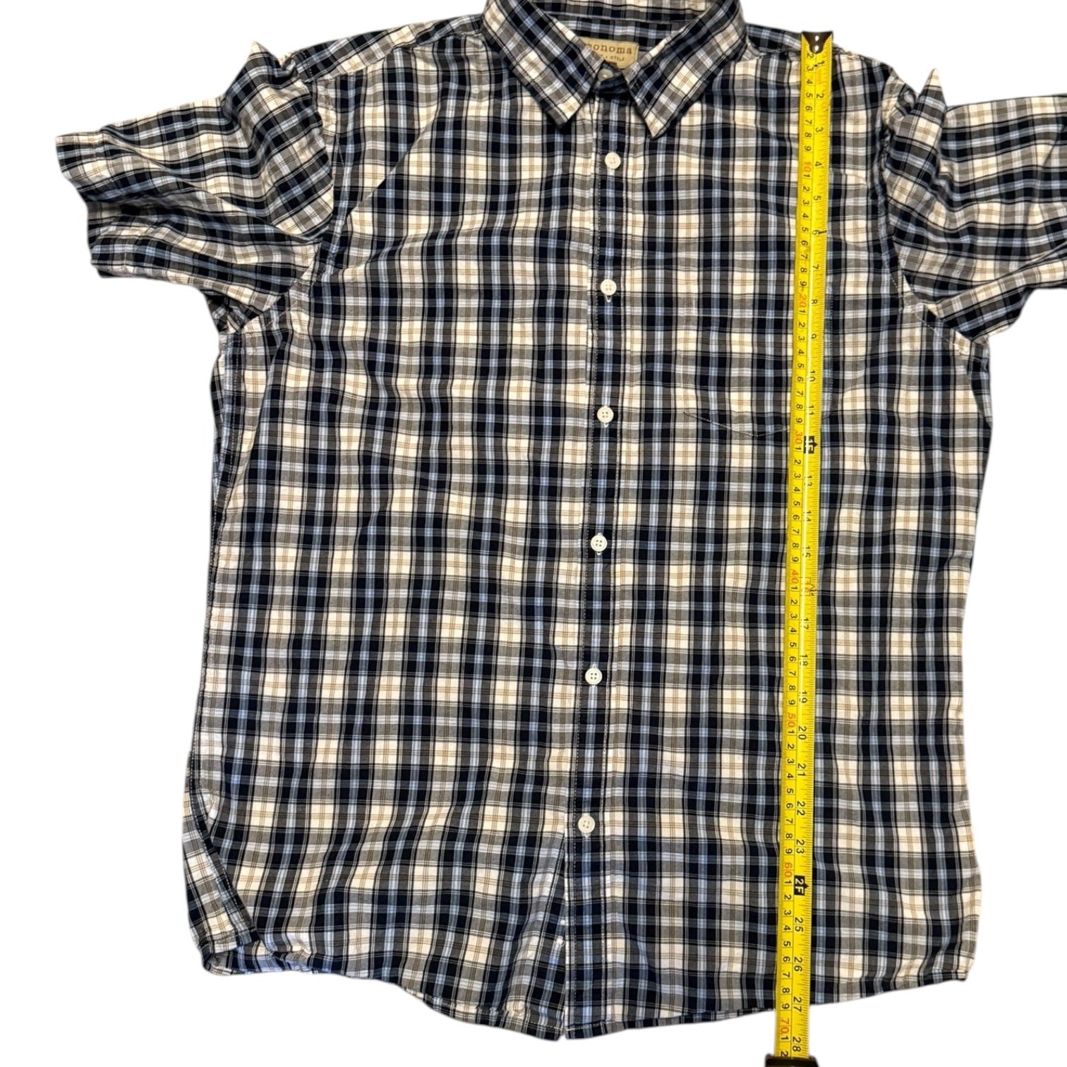 Plaid shirt with a measuring tape for size reference on a white background 