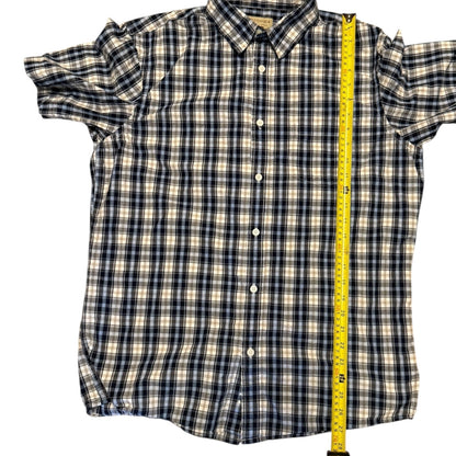 Plaid shirt with a measuring tape for size reference on a white background 