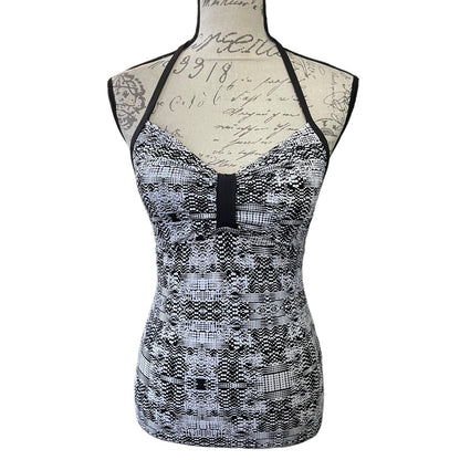 Front of Black and white patterned swim tank top on a mannequin against a white background