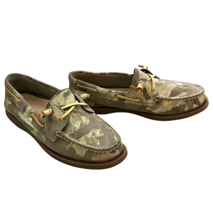 Front side of Camouflage-patterned boat shoes with gold laces on a white background