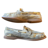 Side view of Pair of camouflage-patterned loafers with gold accents on a white background