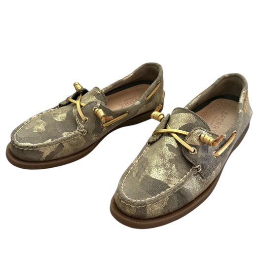 Front side Pair of camouflage-patterned boat shoes with gold laces on a white background