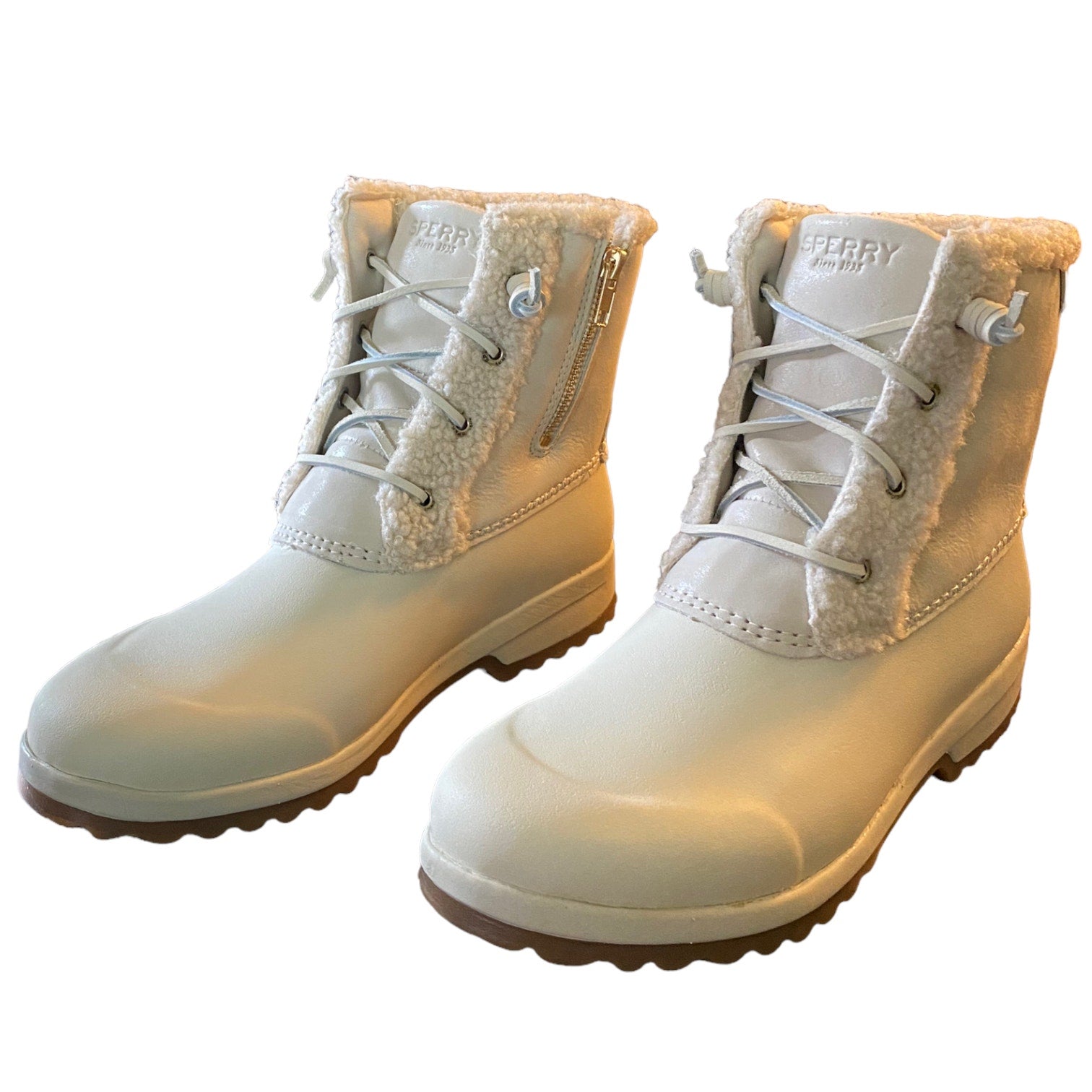 Pair of winter boots with fur lining on a white background