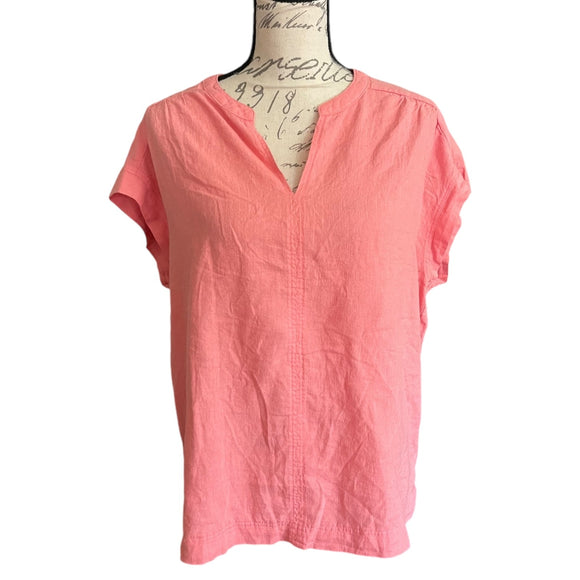 Front of Coral pink blouse on a mannequin with a white background