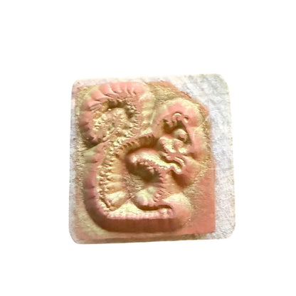 Rubber stamp with ink marks on a white background