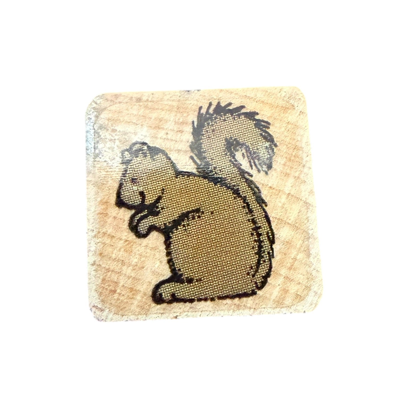 Square wooden stamp with a squirrel design on a white background