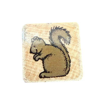 Square wooden stamp with a squirrel design on a white background