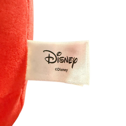 Close-up of a red plush item with a sewn-on Disney label on a white background.