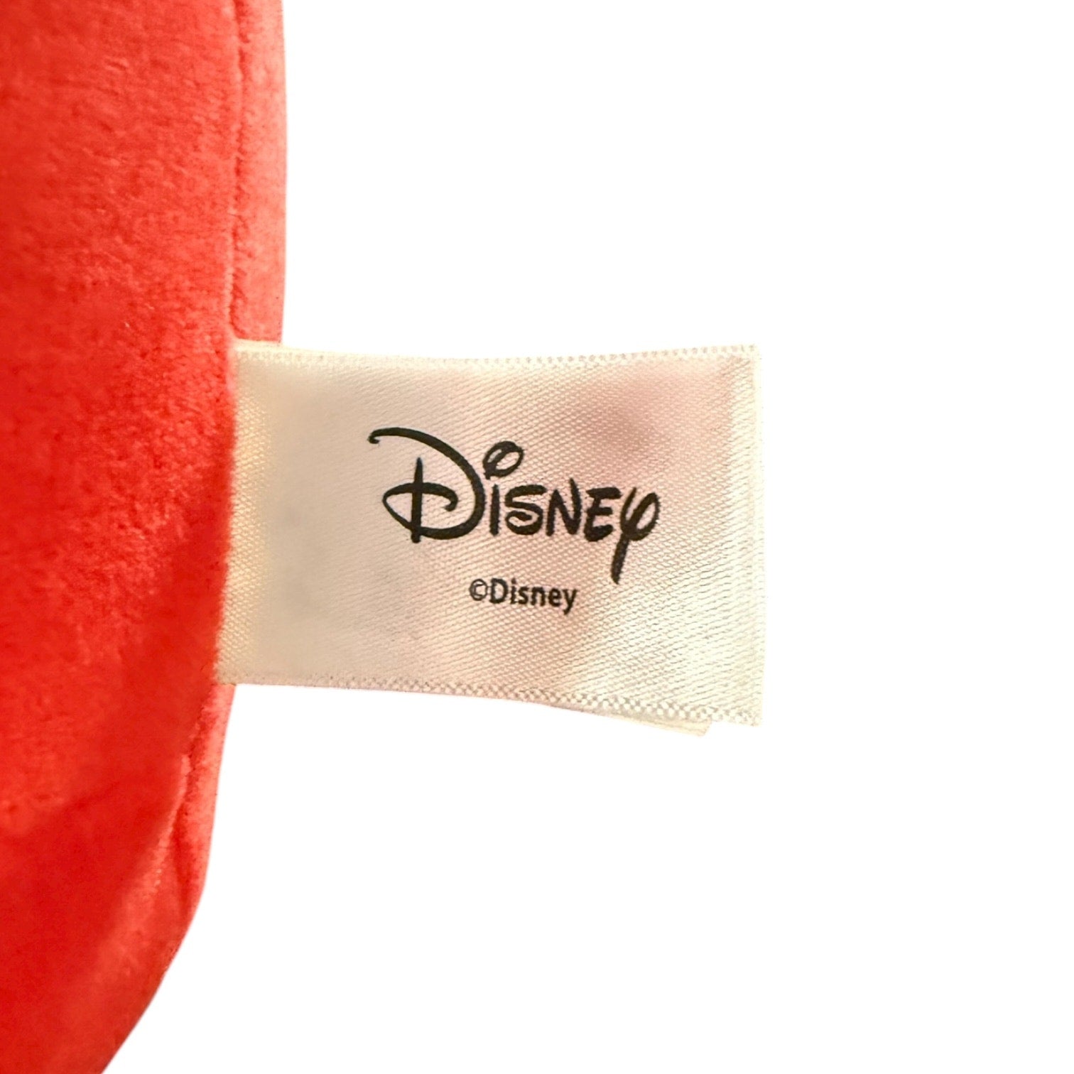 Close-up of a Disney label on a red product with a white background