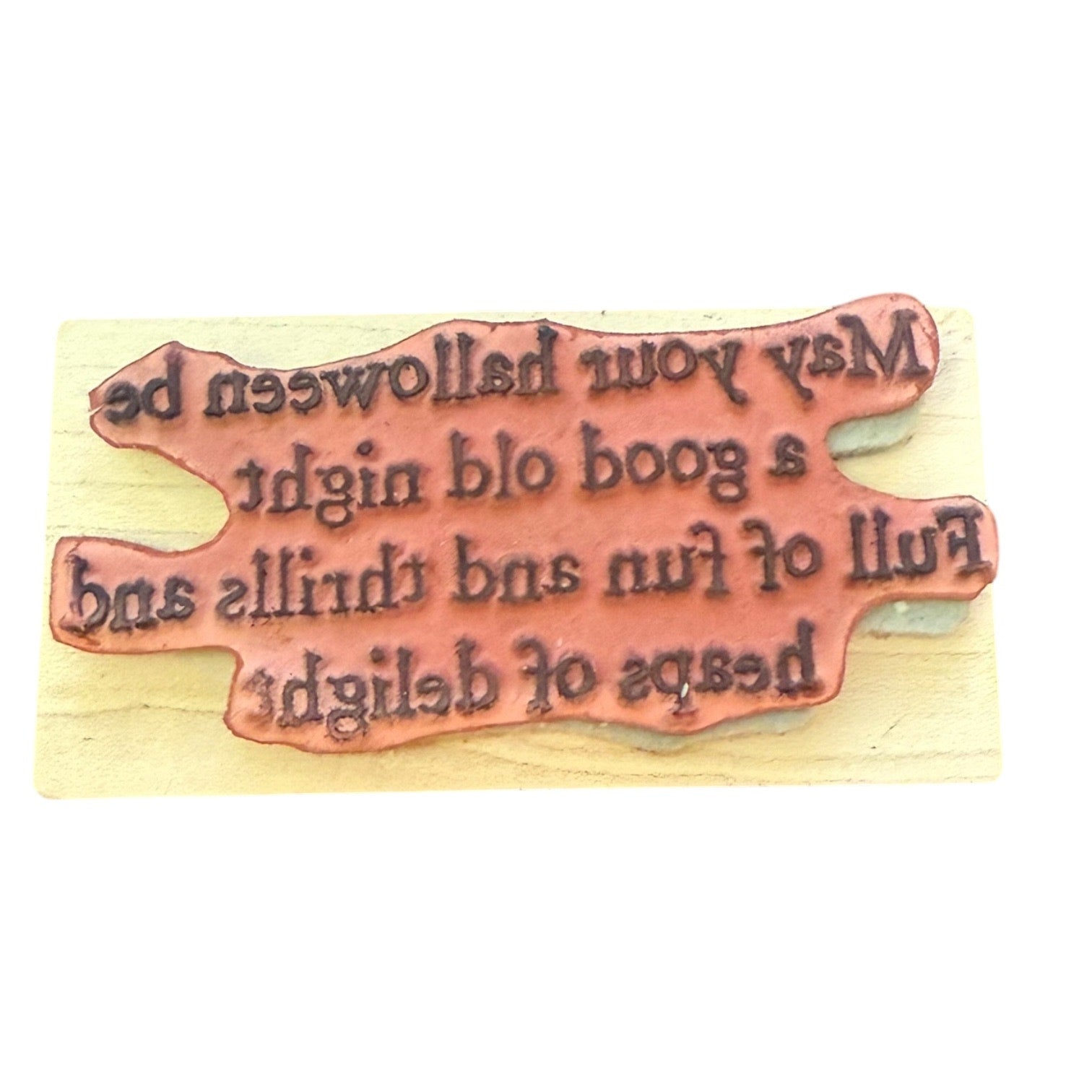 Wooden stamp with engraved text on a wooden background