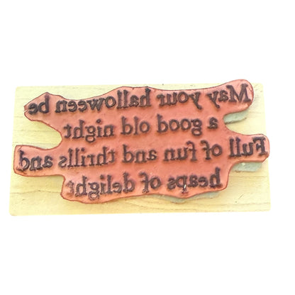 Wooden stamp with engraved text on a wooden background