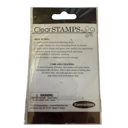 Clear STAMPS stamping block packaging by Stampabilities, showing the back of the clear plastic bag with printed instructions, a warning label, and the Stampabilities logo.