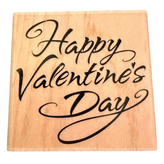 A square wooden stamp with the phrase 'Happy Valentine's Day' written in black cursive script, shown on a plain white background.