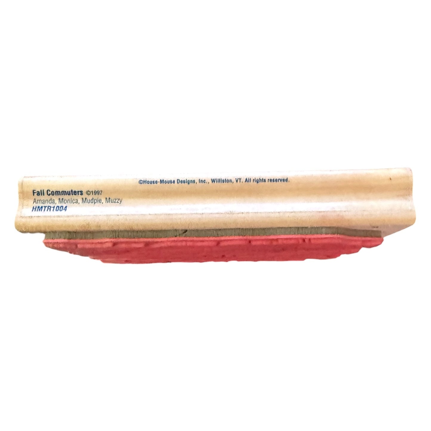 A wooden stamp with a red rubber face, featuring printed text on the side including 'Fall Commuters' and 'Offices Mows Designs, Inc.', shown against a plain white background.