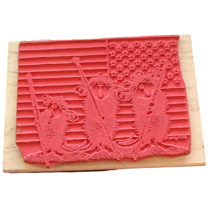 A red rubber stamp mounted on a light-colored wooden block.