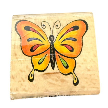 Butterfly-shaped wooden stamp on a white background