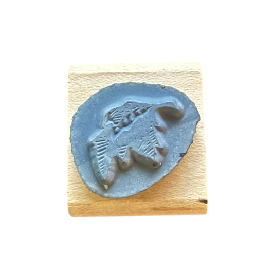 Decorative gray leave stamp design on a wooden block