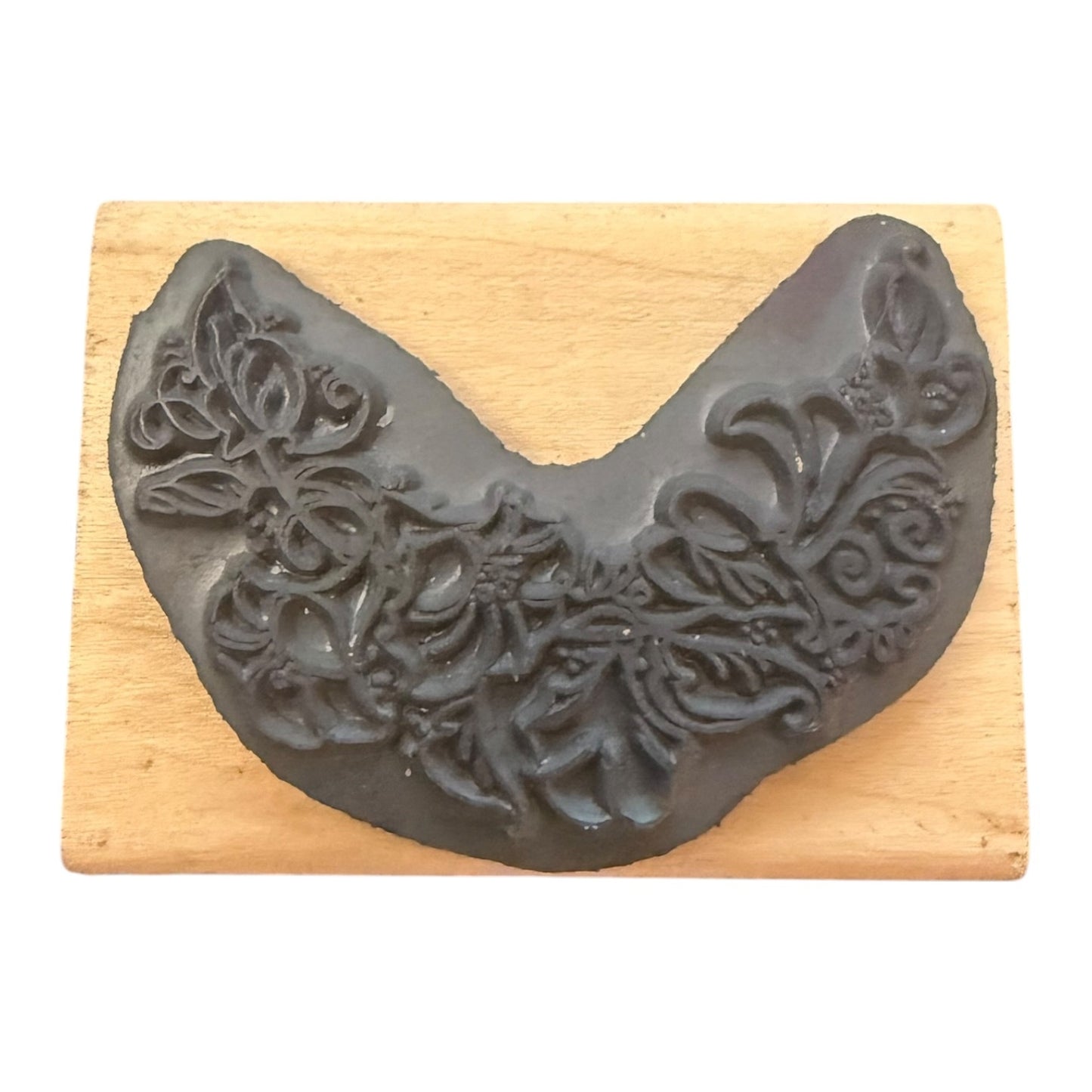 Decorative gray rubber stamp on a wooden block