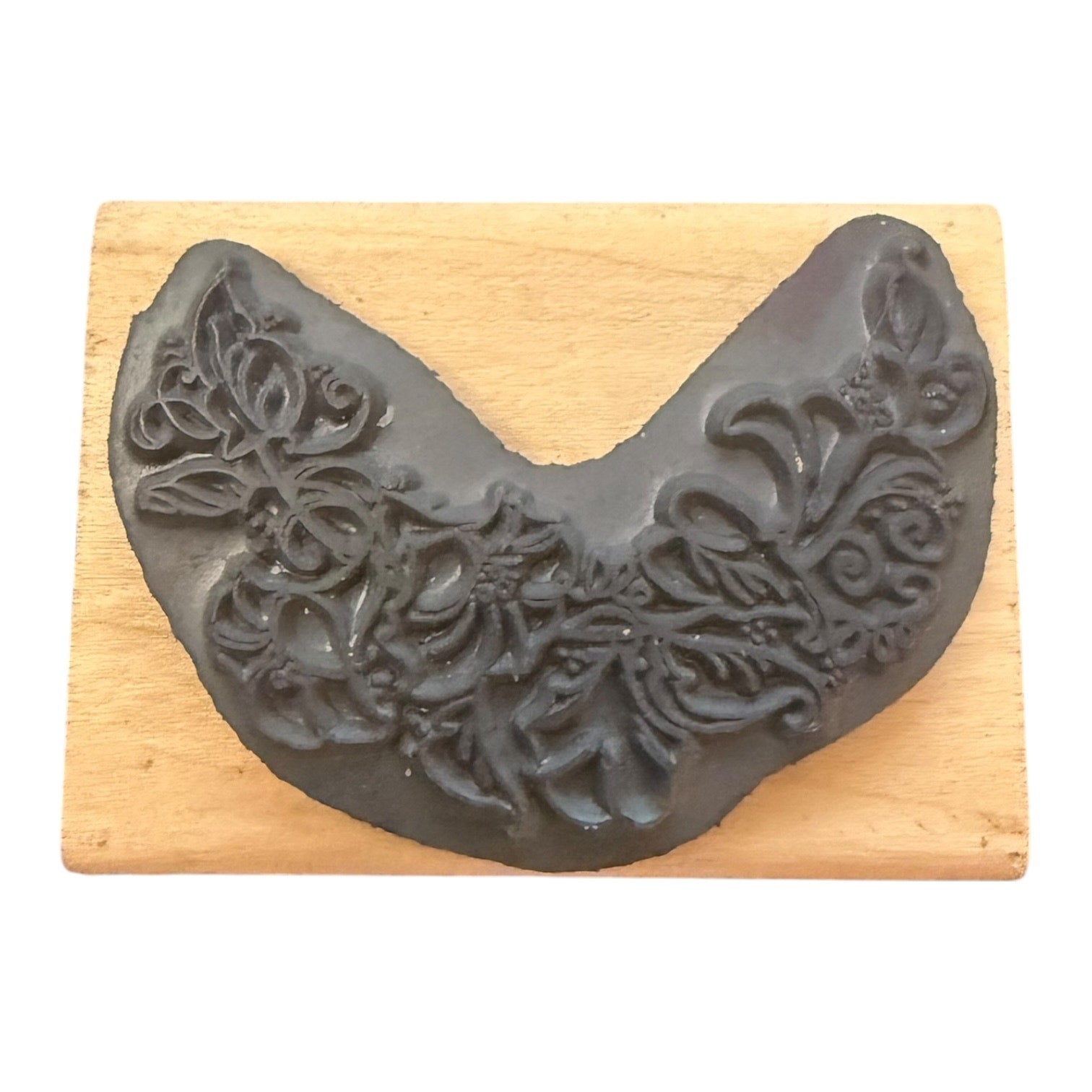 Decorative gray rubber stamp on a wooden block