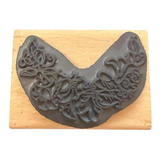 Decorative gray rubber stamp on a wooden block