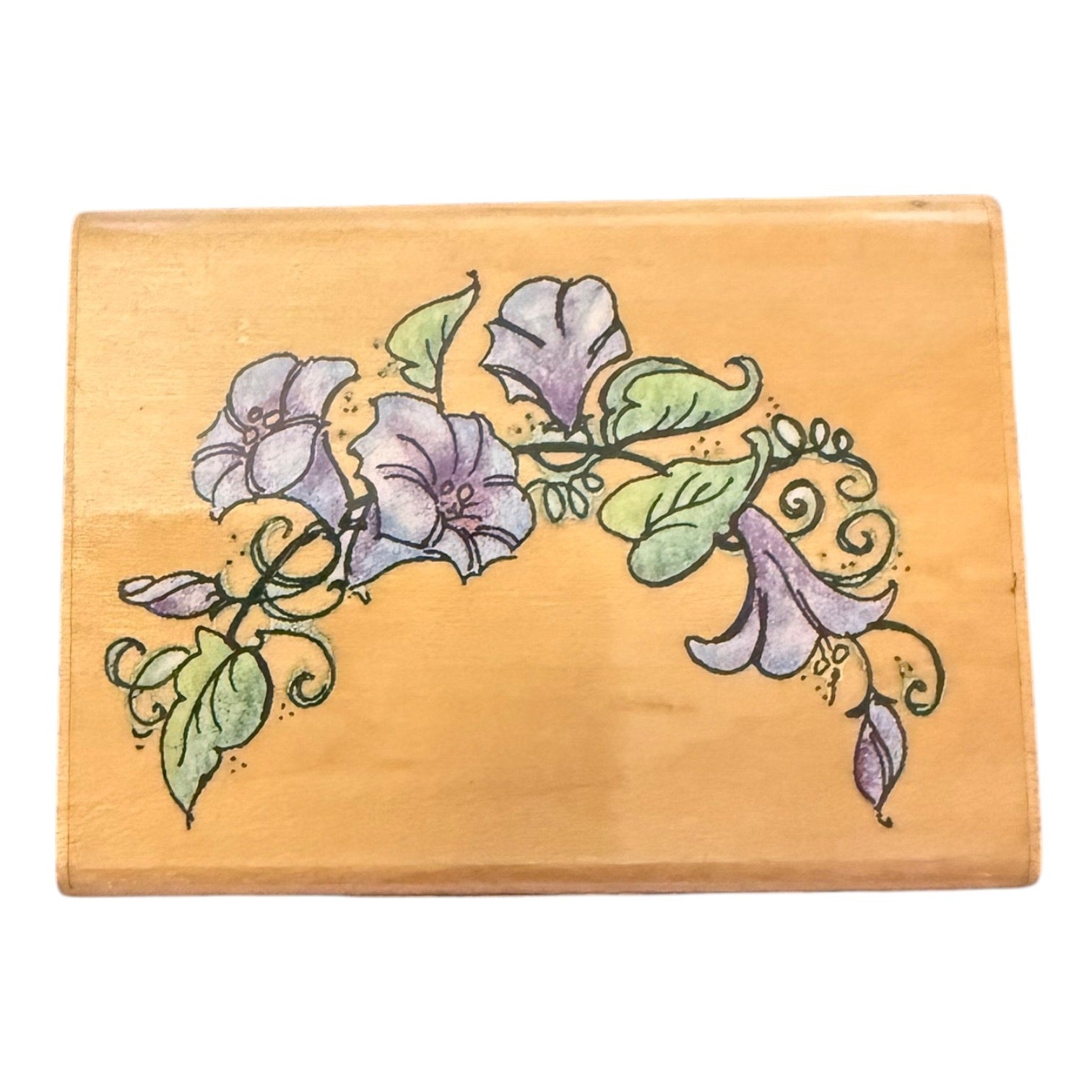 Wooden block with floral design on a white background