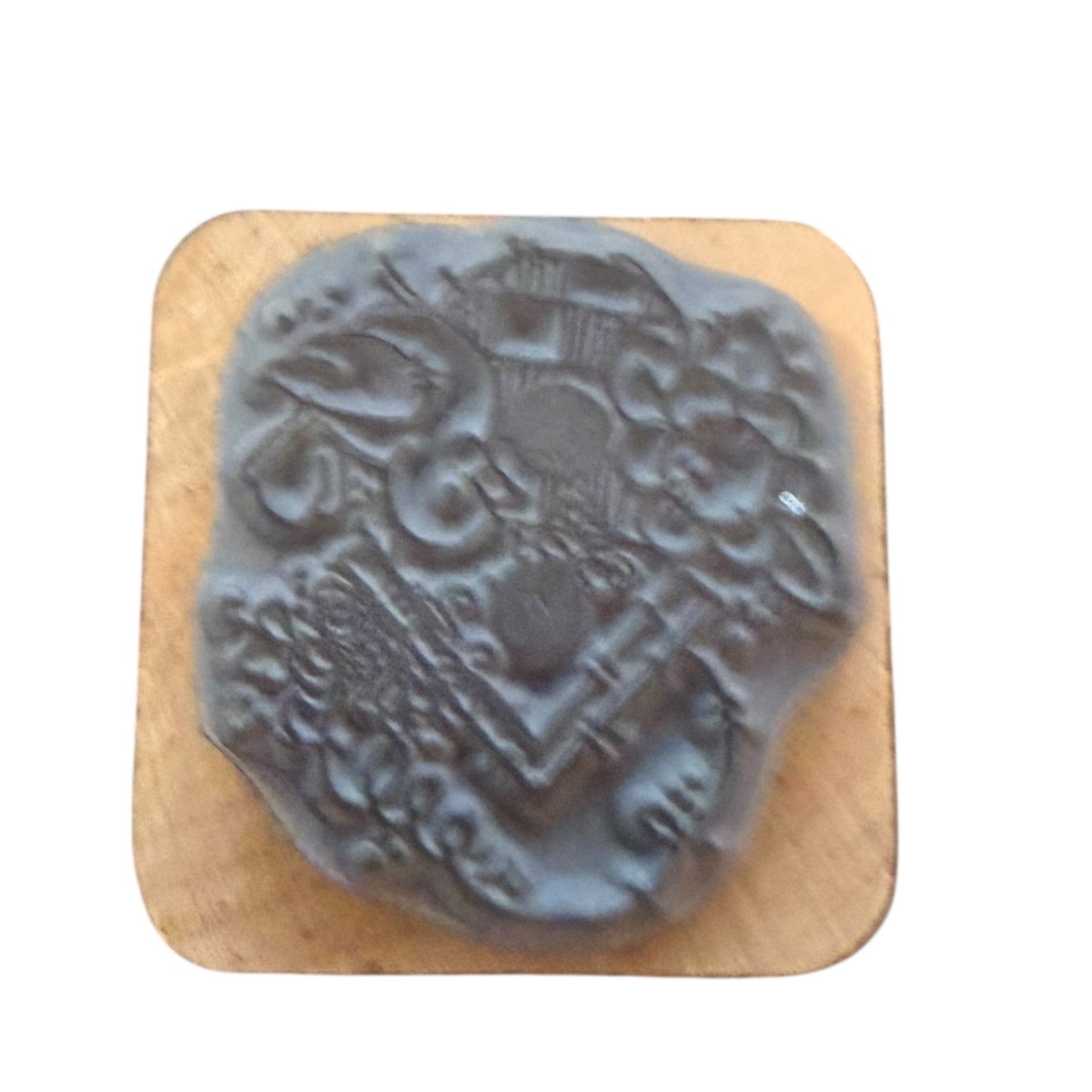 Gray rubber stamp on a wooden base