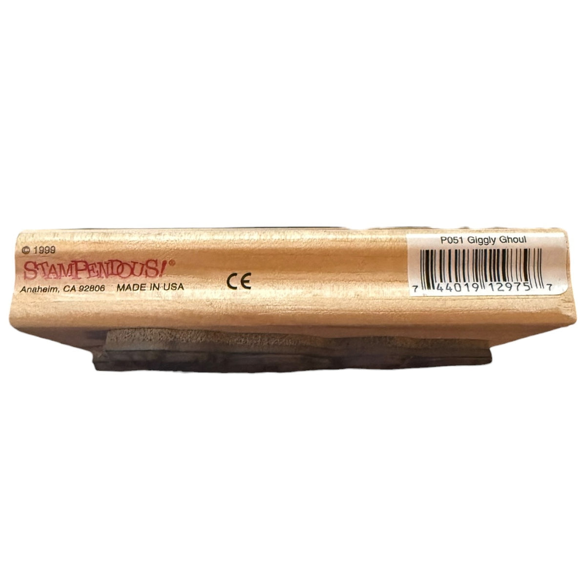 A wooden stamping block branded 'STAMPENDOUS!' with a barcode label on the side, photographed against a plain white background.