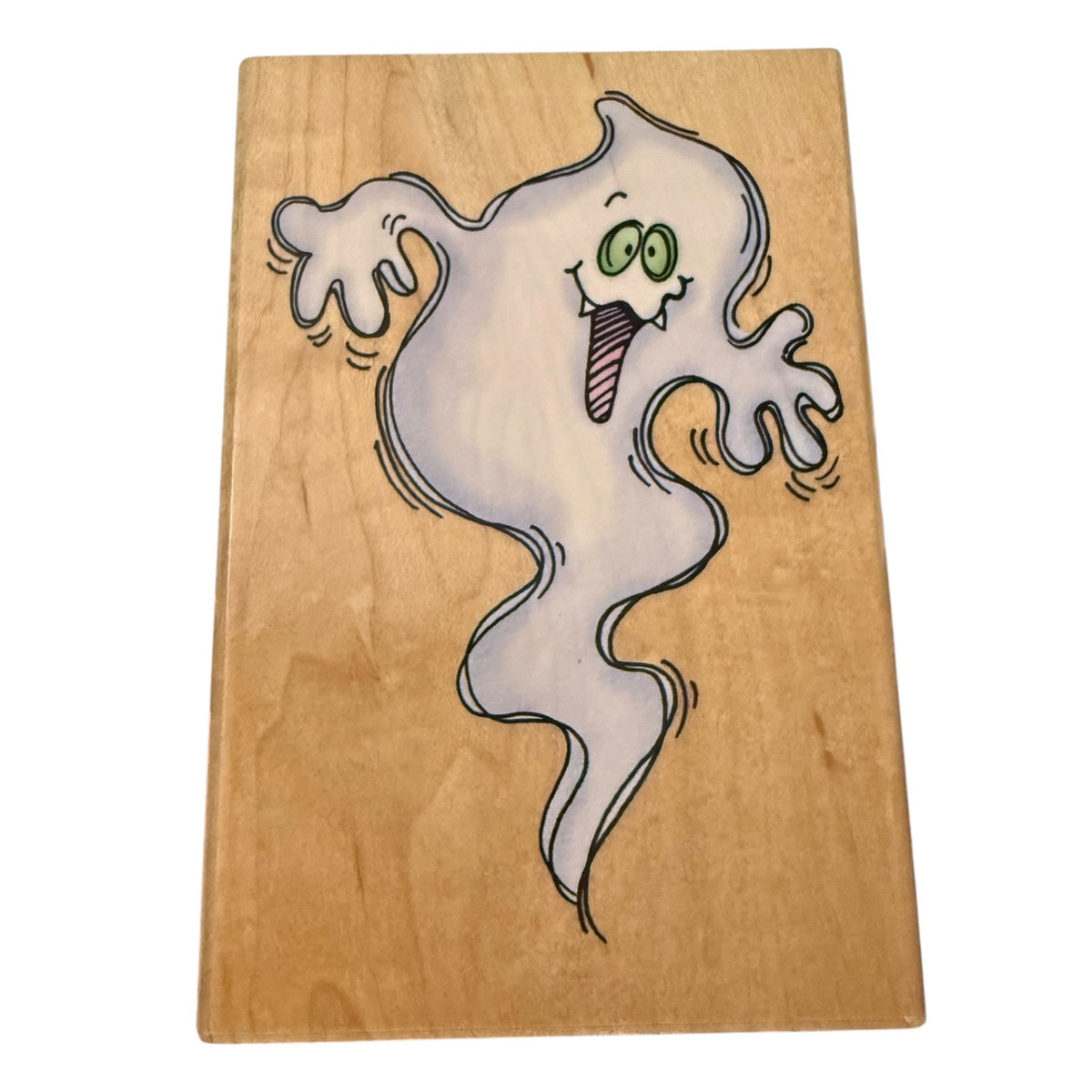 A rectangular rubber stamp featuring a  cartoon ghost in white with green eyes , set against a light wood grain background.
