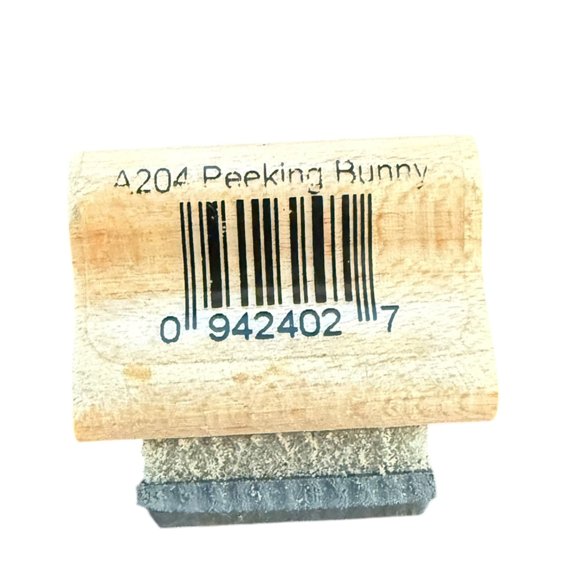 A wooden novelty stamp with a barcode and the text 'A204 Peeking Bunny' on a light wood block, with a dark gray rubber stamp foot visible below, set against a plain white background.