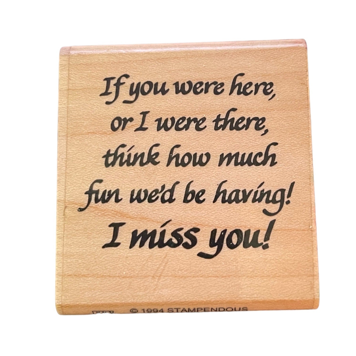 Front of Wooden stamp with engraved text on a white background