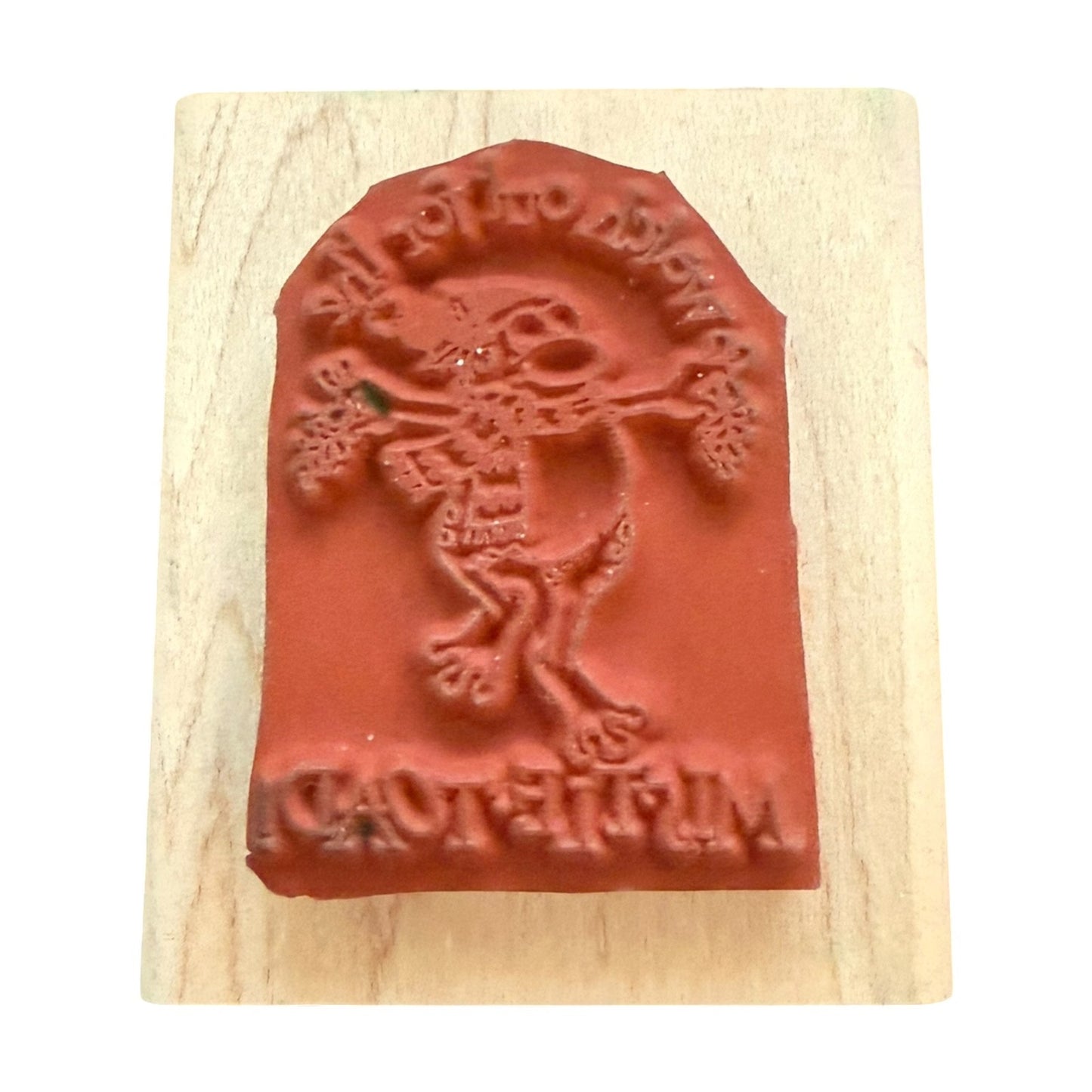 A rubber stamp featuring a cartoon toad character mounted on a light-colored wooden block.