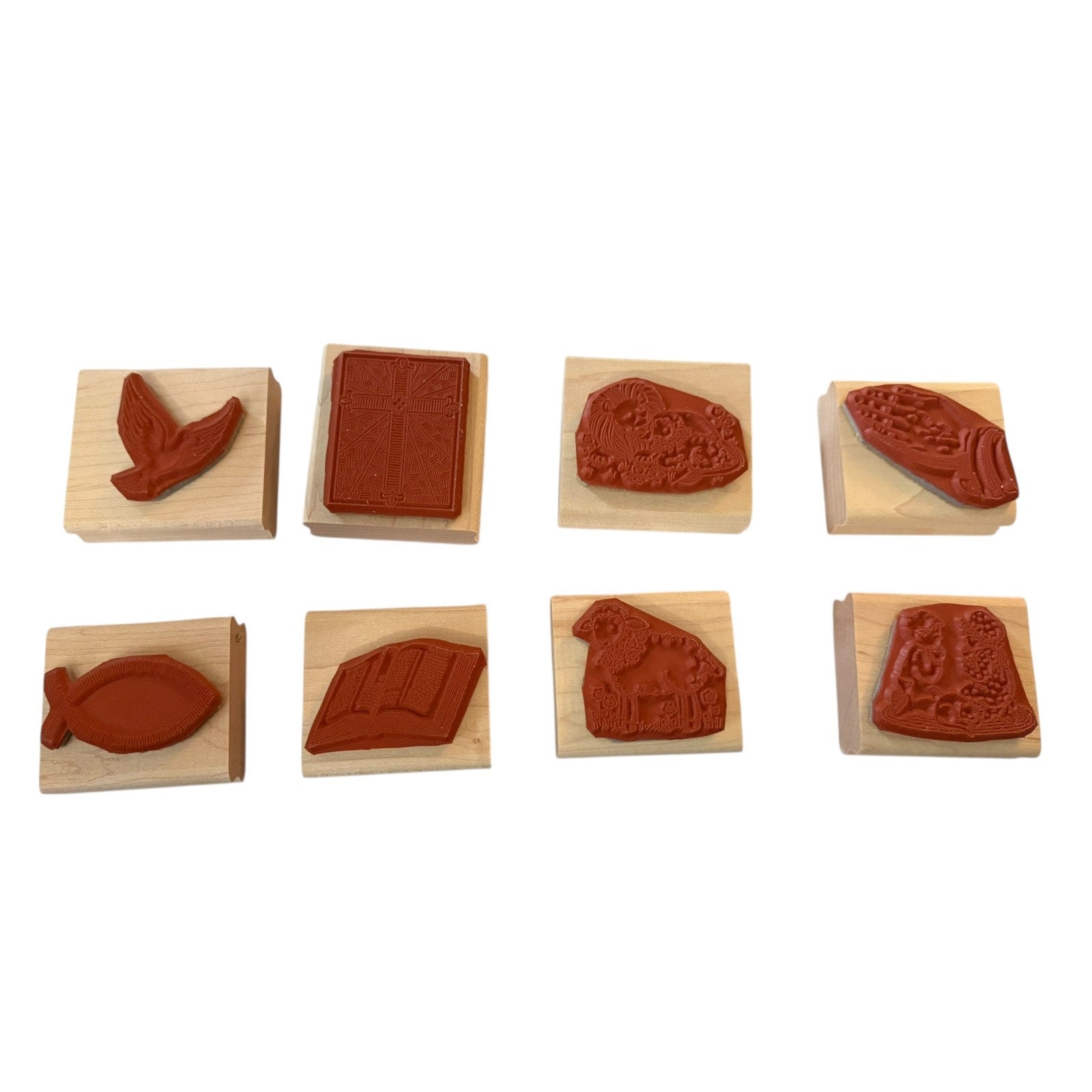 Set of eight wooden stamps with religious designs on a white background