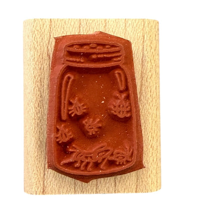 Wooden stamp with a red rubber stamp on a white background