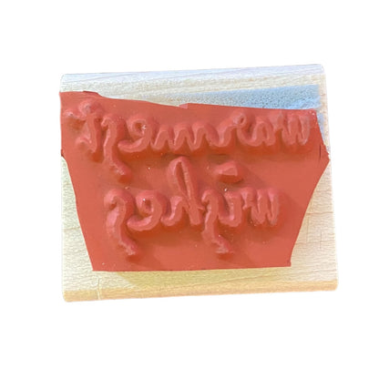Rubber stamp with red rubber pad on a white background